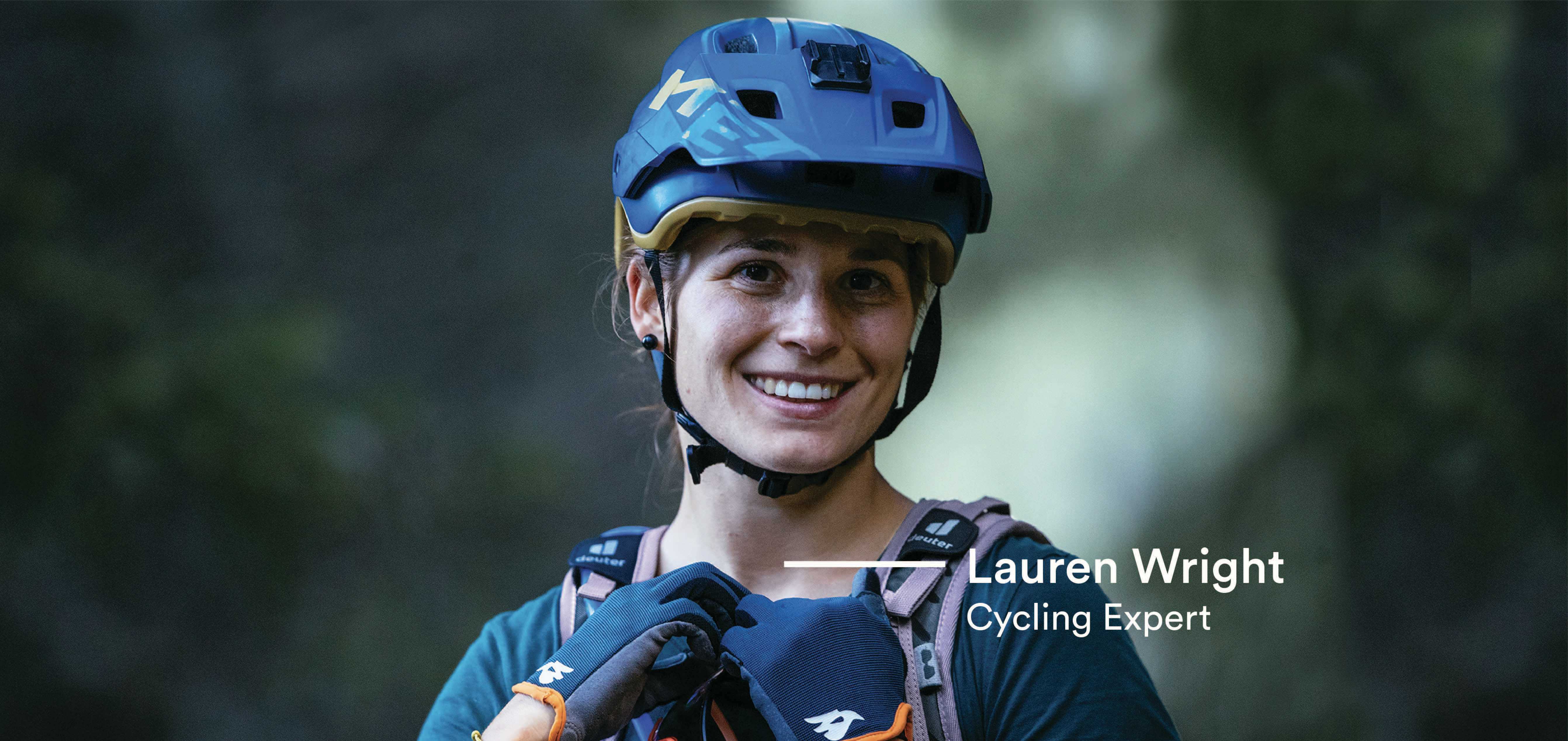 Cycling Expert Lauren Wright smiles at the camera while wearing a blue helmet. 